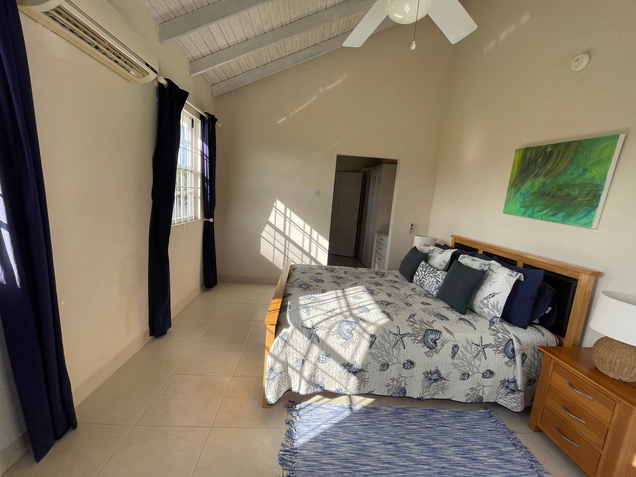 Holland Park Villa double bedroom with vaulted ceiling and tropical artwork